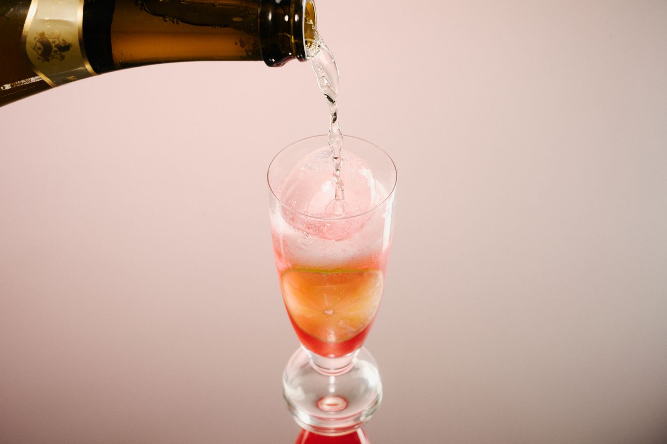 Topping up the Midnight Mimosa with sparkling wine