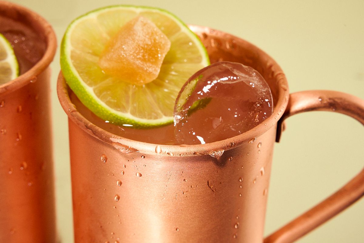 A close shot of the Moscow Mule with ice, a lime wheel and crystallised ginger.