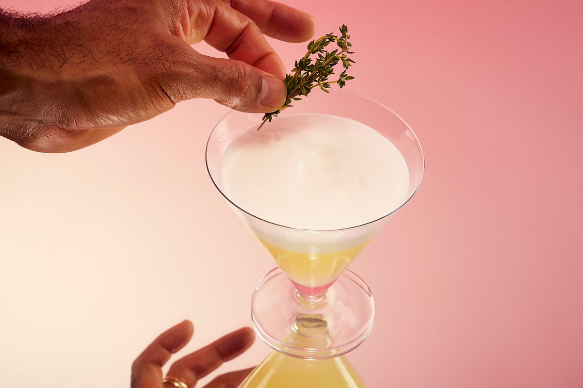 Garnishing the Non-Alcoholic Sour with fresh thyme