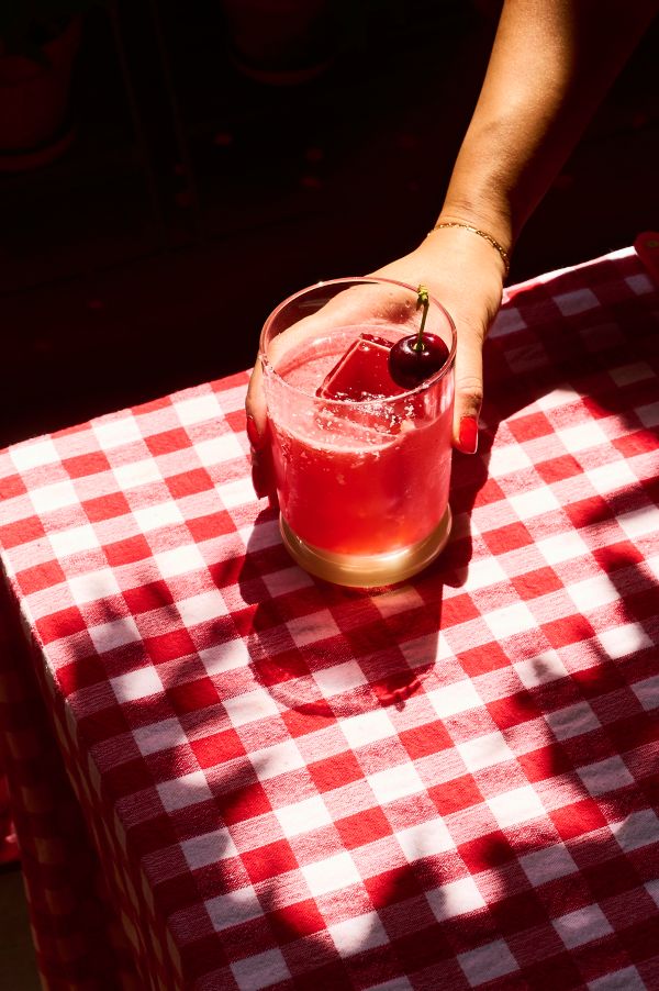 Holding a Cherry Margarita that's garnished with a fresh cherry 