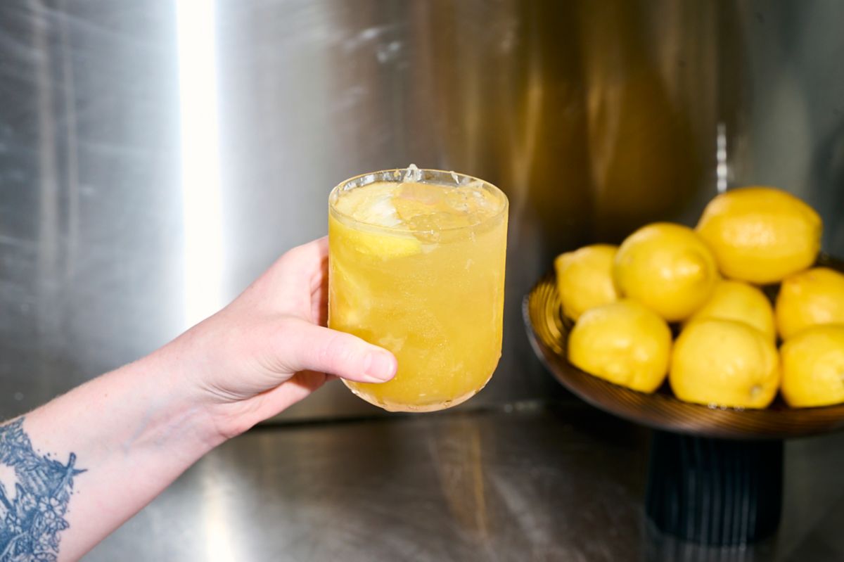 Holding the Passionfruit Caipiroska cocktail 