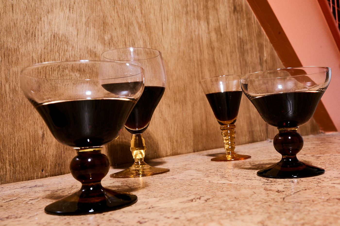 Four glasses of port in vintage-style glasses