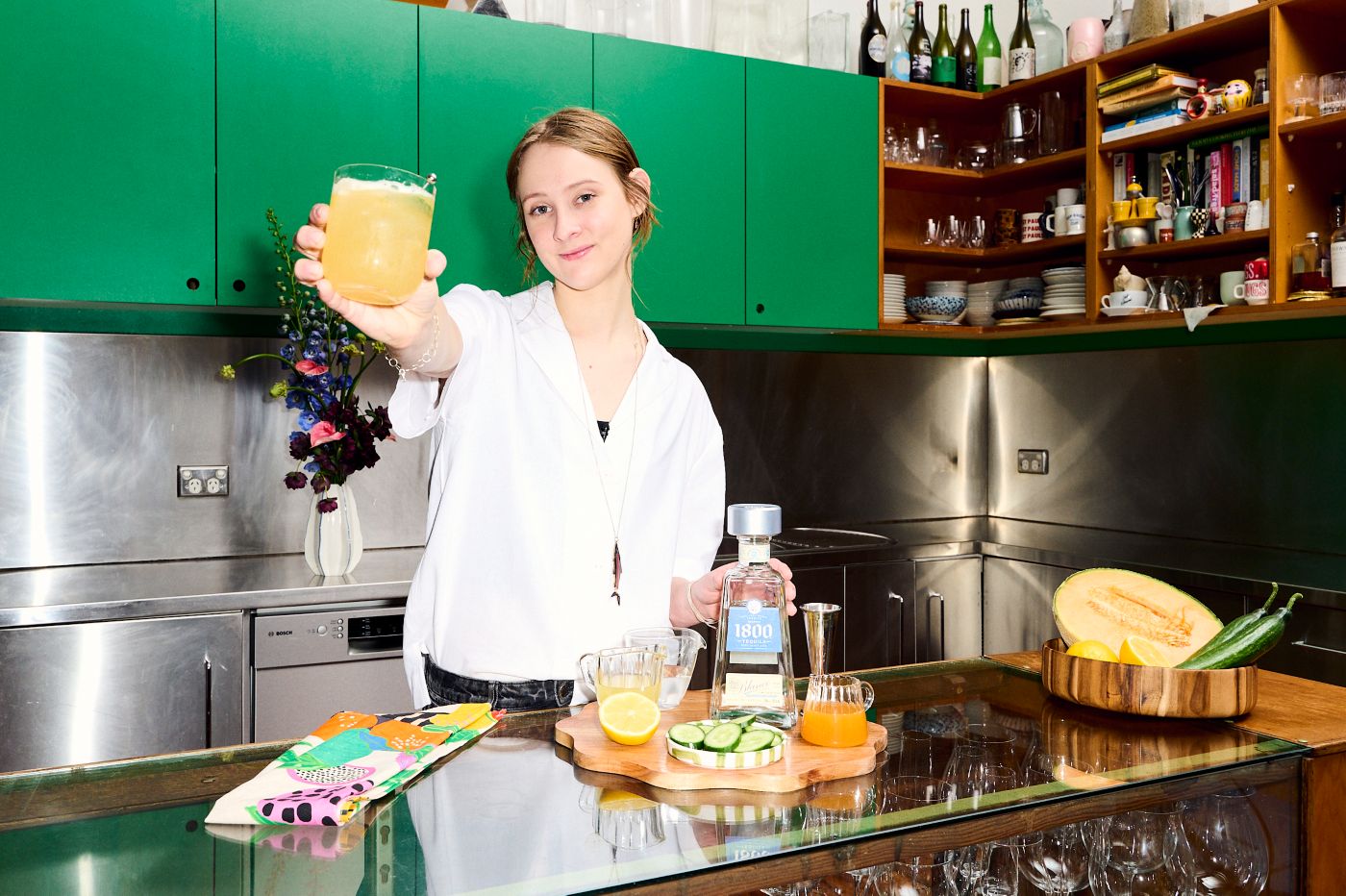 Bartender Andie Bulley holding the Pepino's Gun cocktail