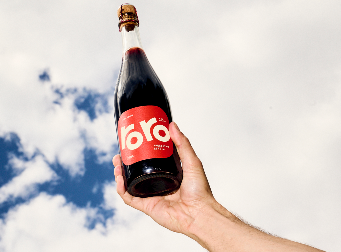 Holding a bottle of Zonzo's Roro Apertivo Spritz 