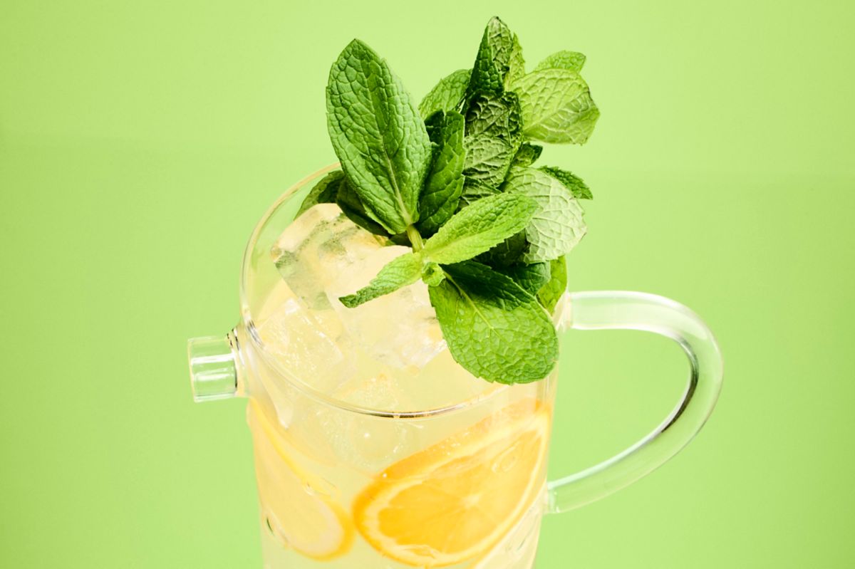 A jug of the DIY Alcoholic Lemonade with fresh mint