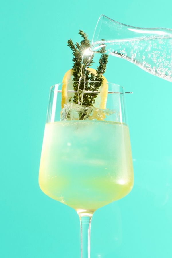 Topping the Limoncello Spritz with soda water