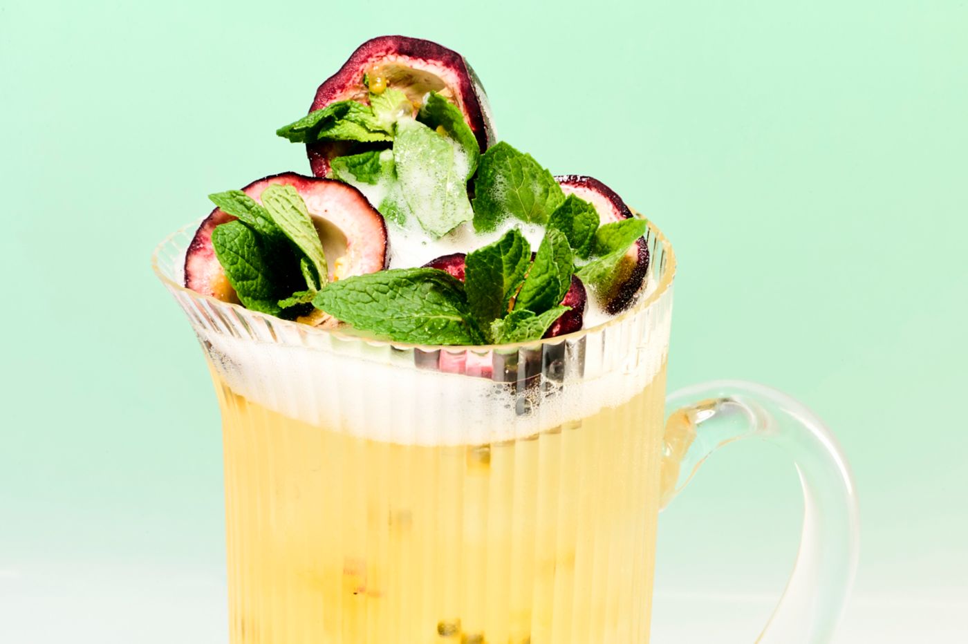 A jug of the Pornstar Martini Spritz, garnished with mint and passionfruit 