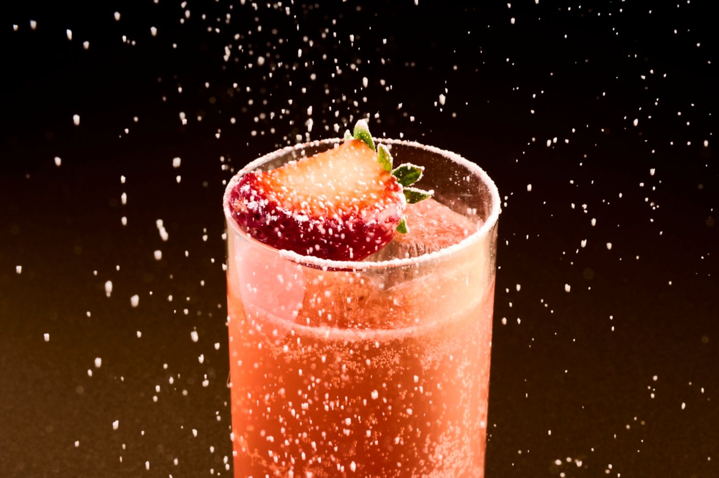 The Sour Strawberry Highball getting finished with icing sugar on top 