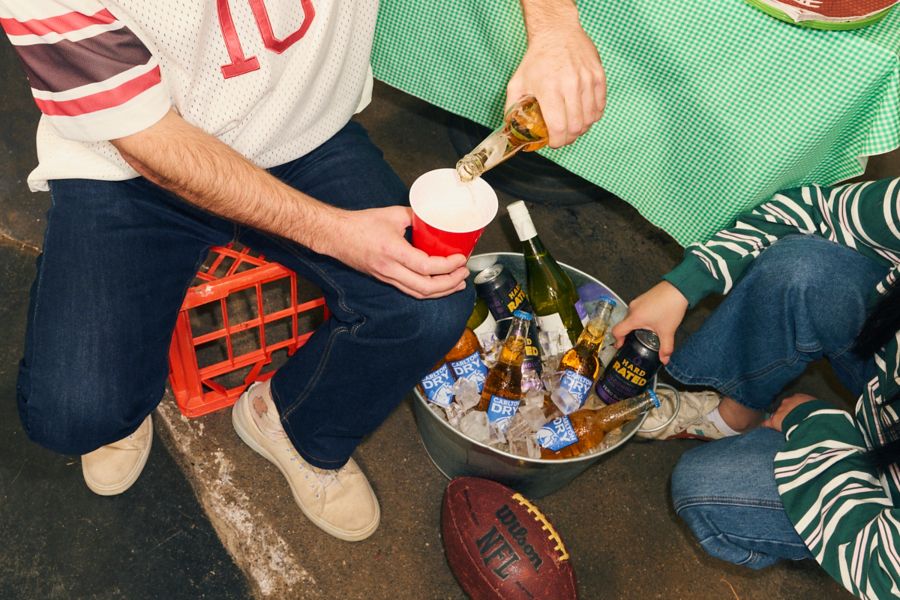 Pouring a beer from a choice of brews in an ice bucket