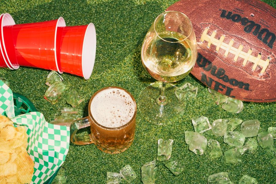 Beer and wine with Amercian red cups on grass
