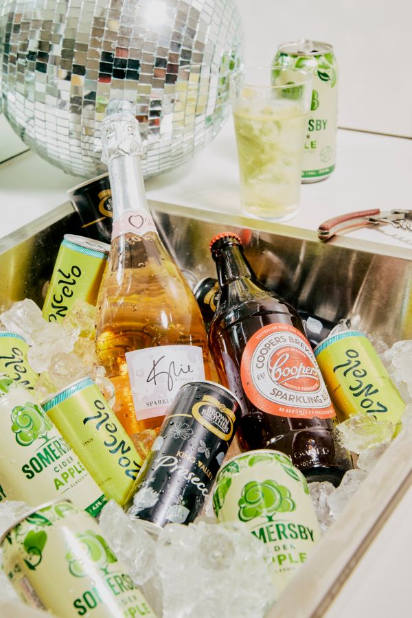 A laundry sink full of drinks in ice for a party 