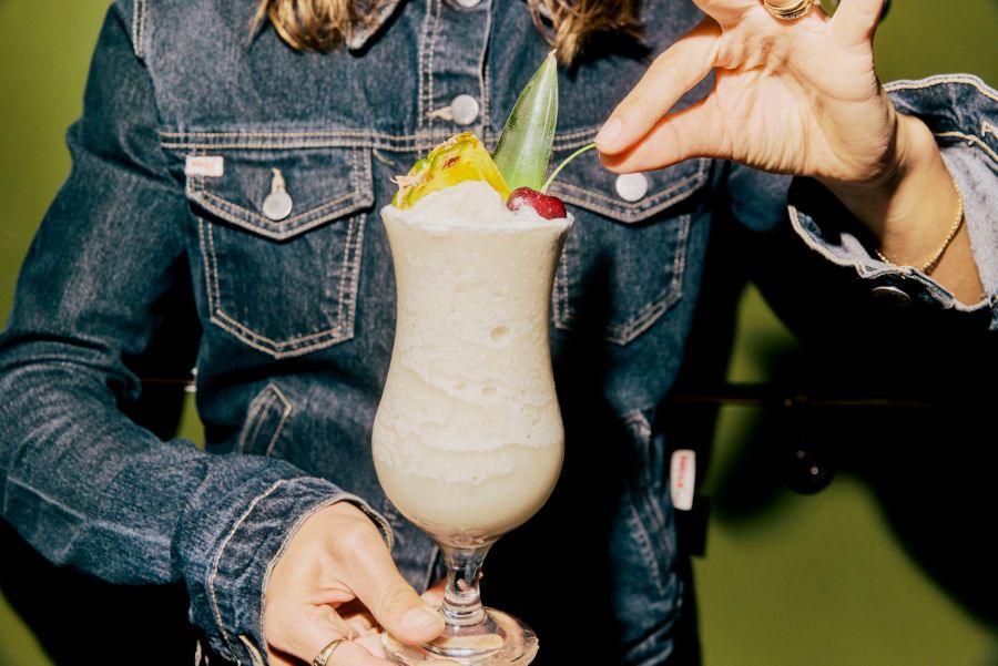 Holding a Hennessy Colada, which is made with Hennessy Cognac