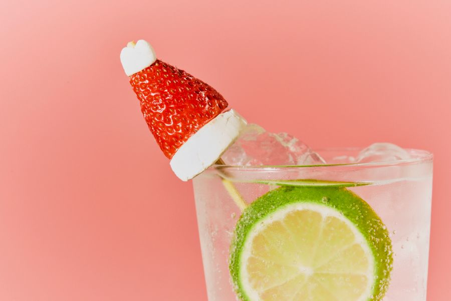 A strawberry and marshmallow garnish that looks like a Santa hat