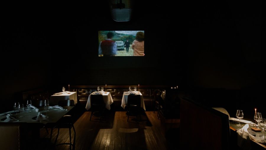 Old Italian films are projected onto the wall at Bianchetto in Melbourne