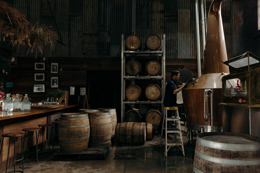 Eddie Brook with barrels of whisky at Cape Byron Distillery